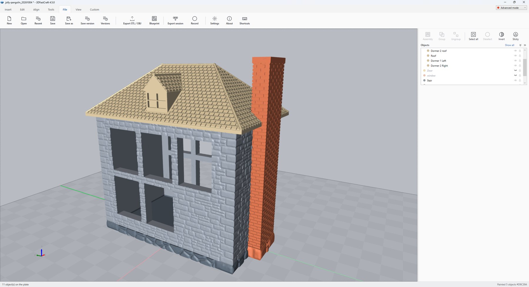 A model house with coursed stone walls on a rubble base, a brick chimney and a tiled roof with a dormer
